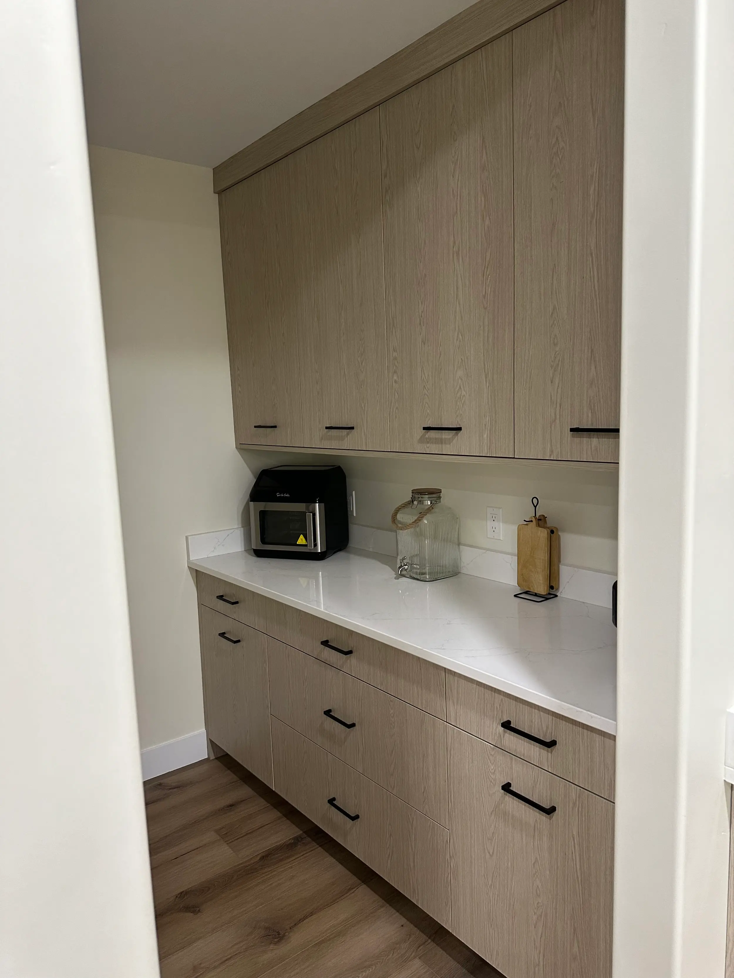 Custom cabinetry framing a dining nook, built to match surrounding kitchen millwork and finished with the same craftsmanship throughout.